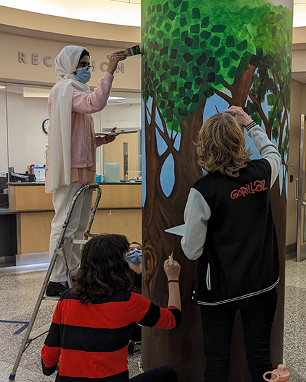 OCVI students painting a pole in the DRCC